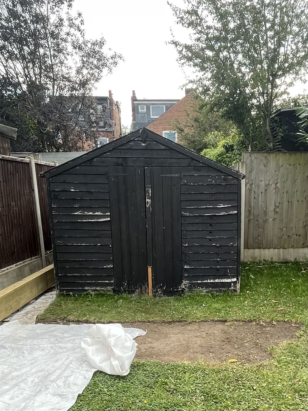 Garden shed before demolition, timber structure still standing