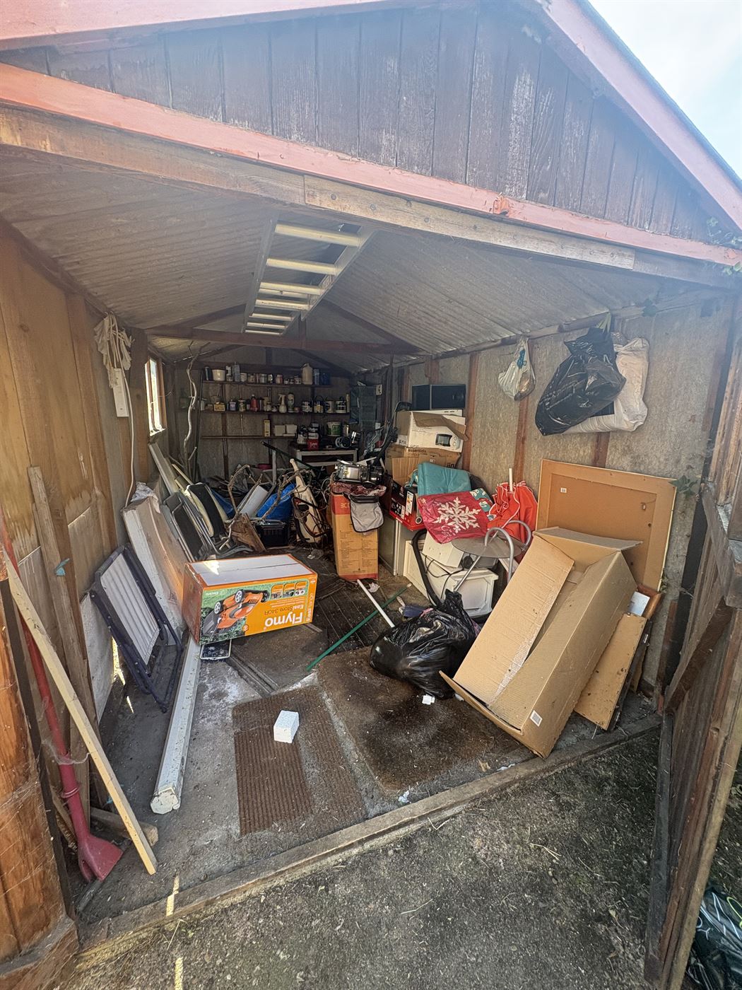 Garage and shed clearance before, the shed packed with boxes, tools and old furniture