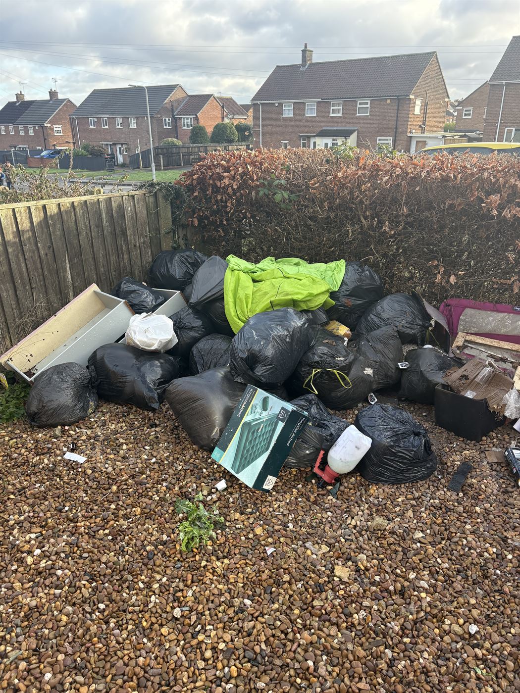 Waste collection before, bags and household waste piled up in a back garden