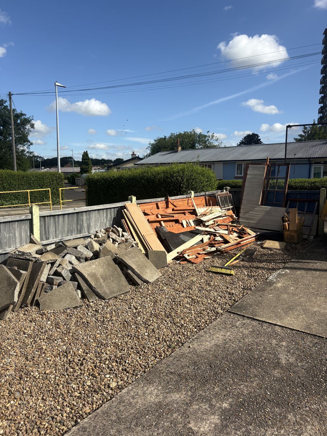 Back garden in Carlton piled with timber, broken slabs and rubble left from a shed the customer had taken down